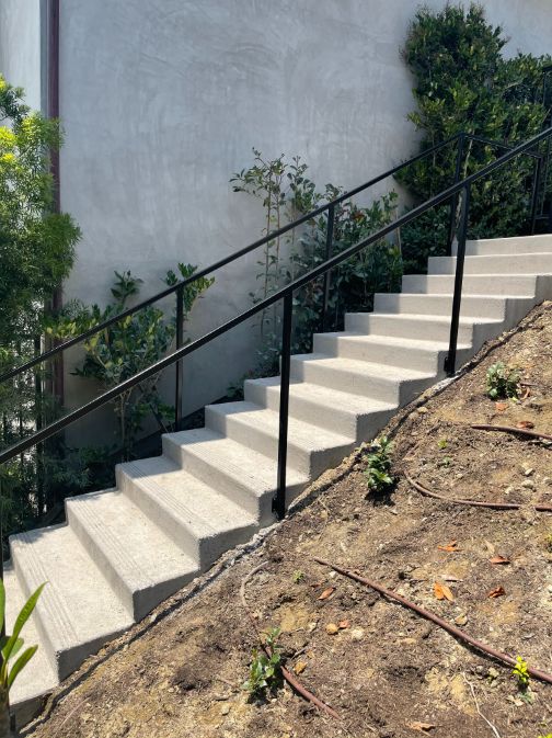 A set of stairs with metal railing on each side.