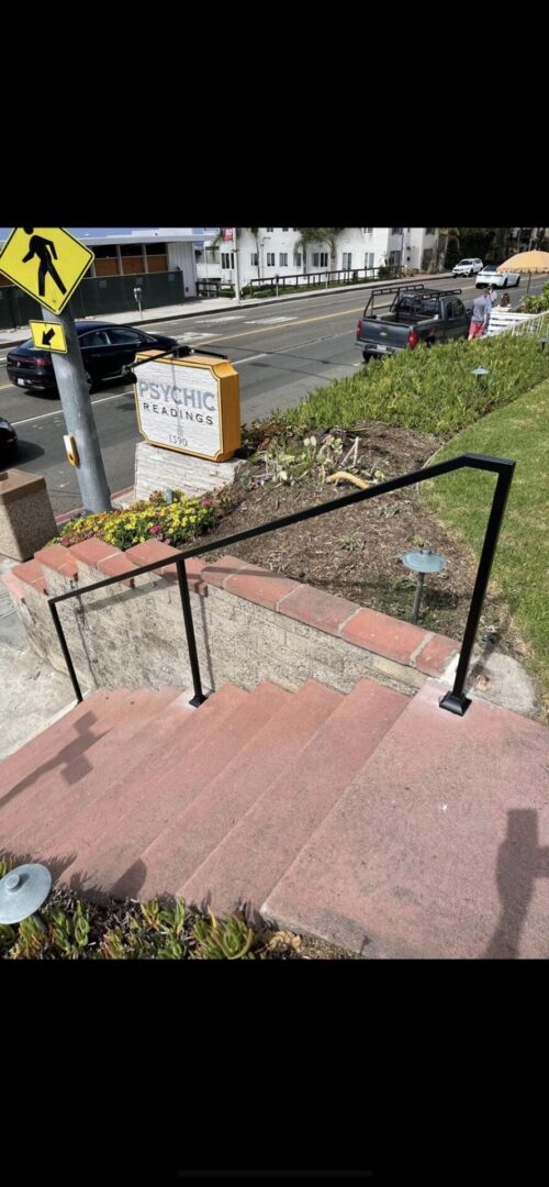 A black metal railing on the side of steps.