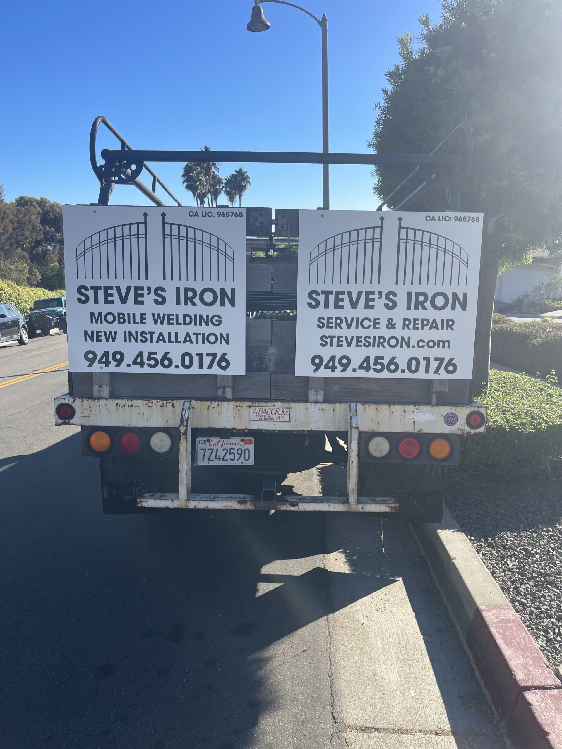 Truck with Steve's Iron advertisement signs.