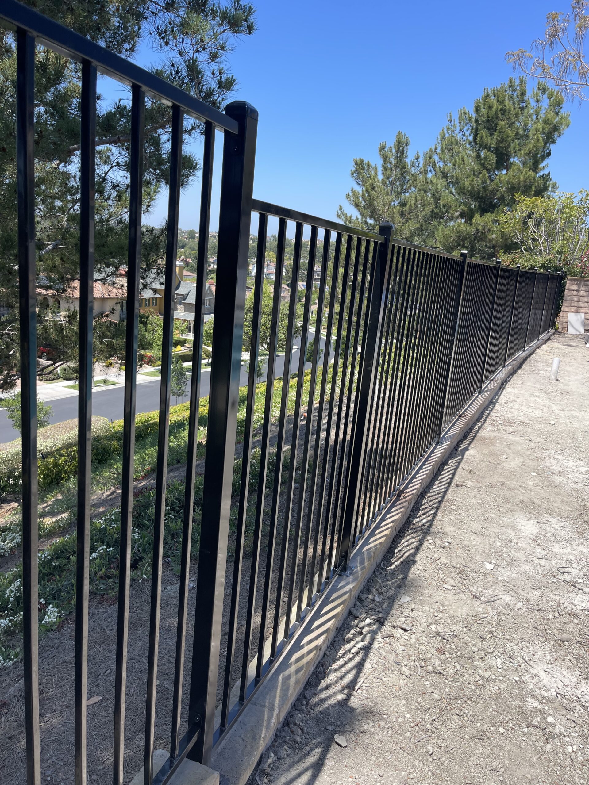 Black metal fence on a hillside.