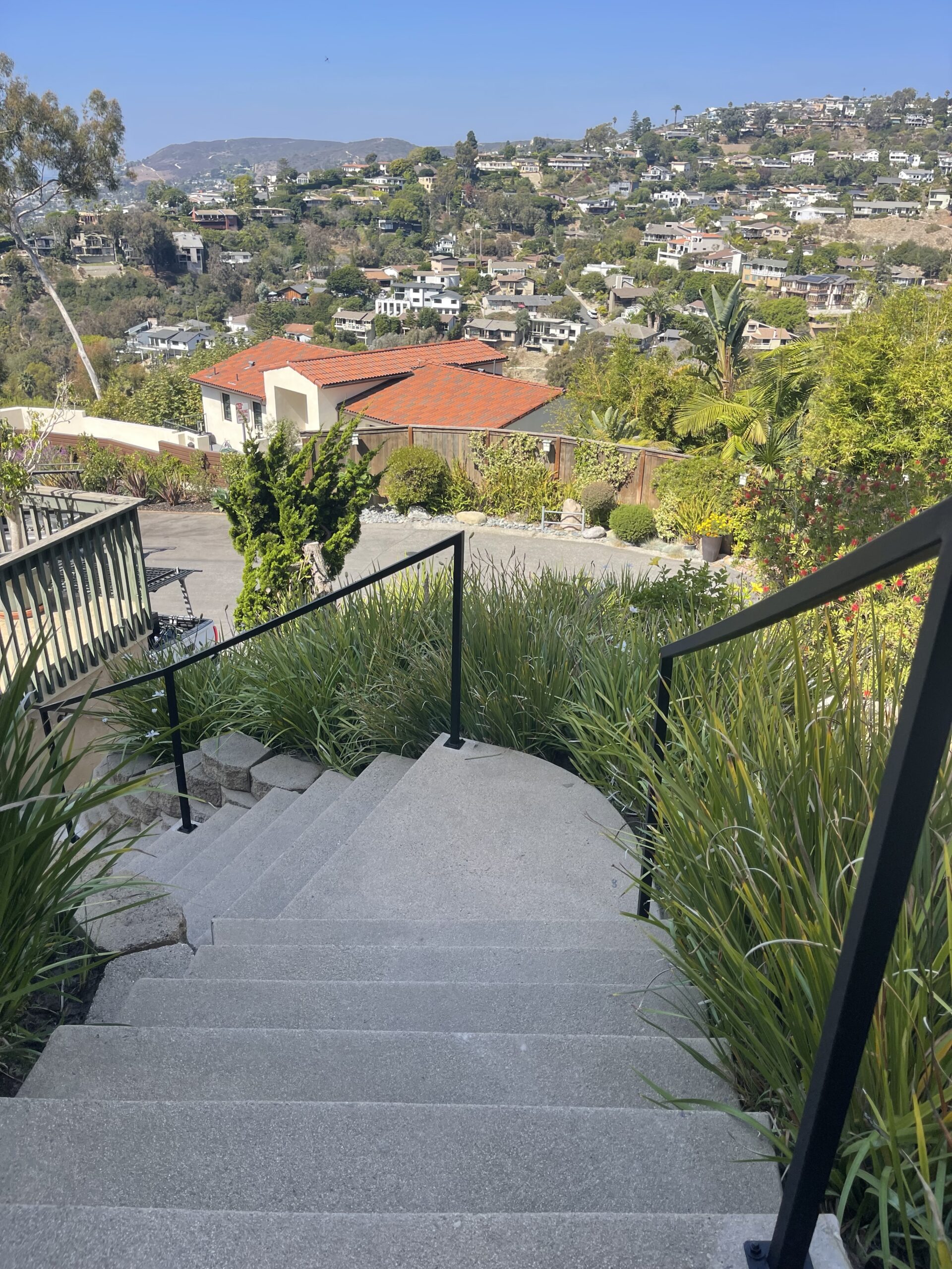 Stairway overlooking hillside residential neighborhood view.